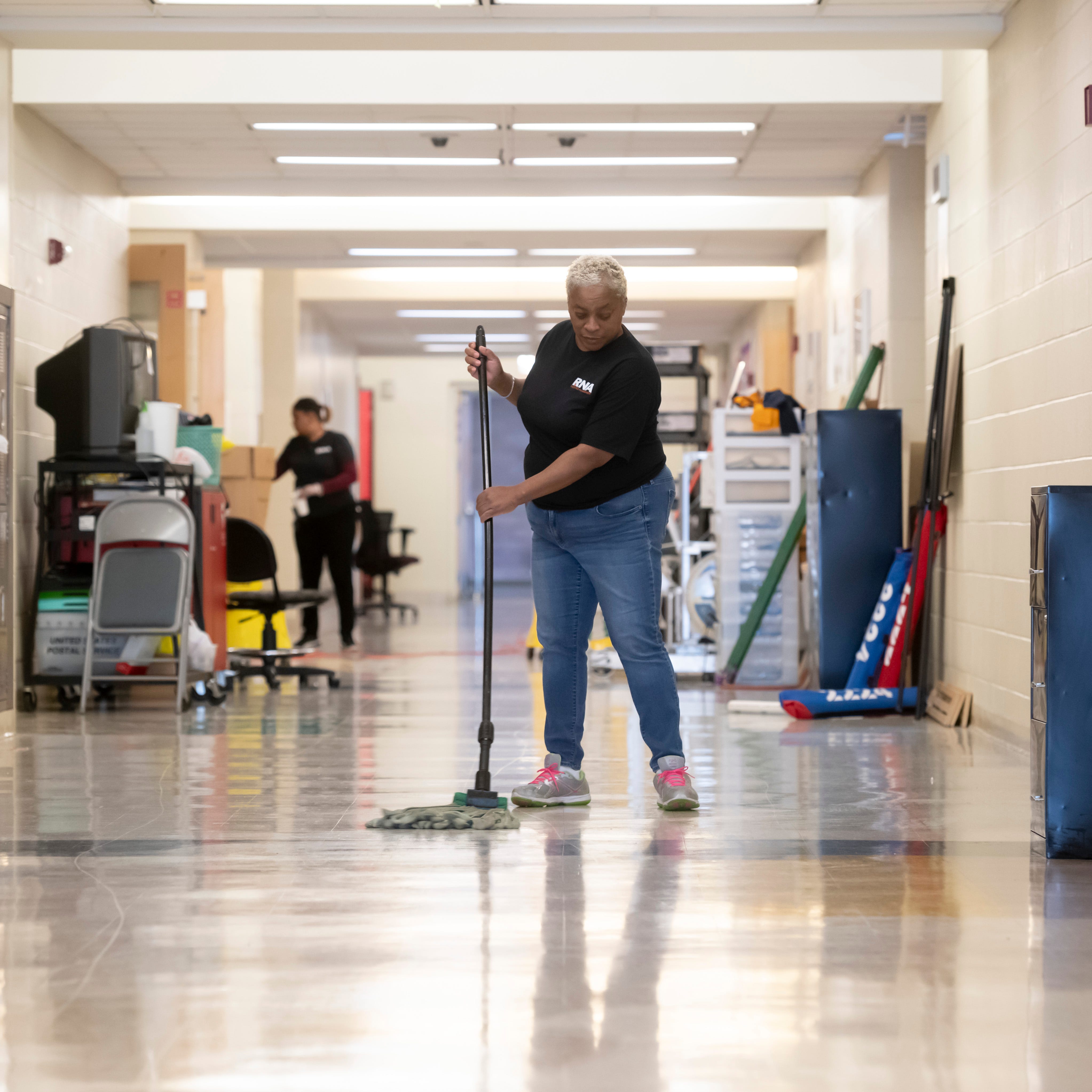 Lorna Bryant, a custodian with RNA Facilities Management, mops the floor inside Renaissance high school, which was being cleaned due to the corona virus, April 2, 2020. Every classroom was emptied of furniture for the cleaning.
