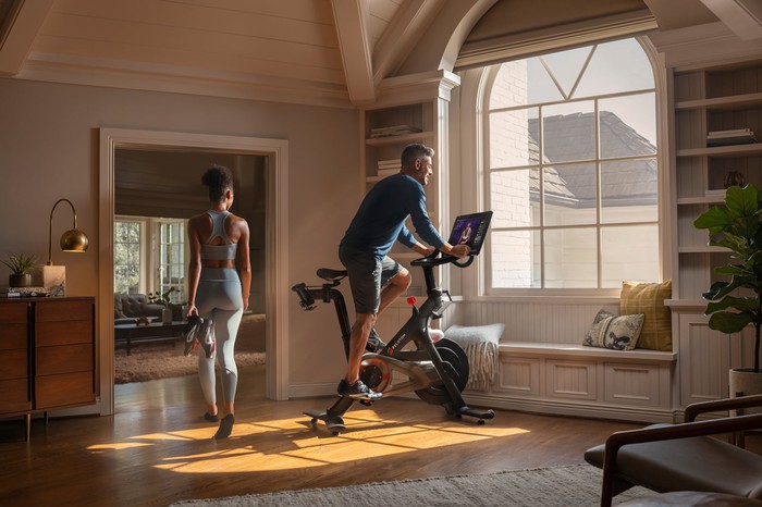 Unfairly fit and beautiful couple working out in upscale home
