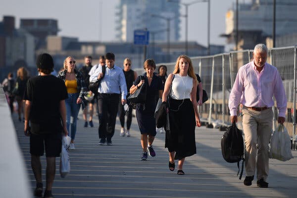 Commuters walking across London Bridge toward the City of London on Tuesday. Britain’s unemployment rate rose above 4 percent for the May-July period. 