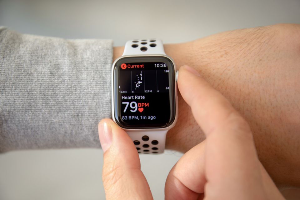 an hand with Apple Watch Series 4 with Heart Rate on the screen. Apple Watch was created and developed by the Apple inc