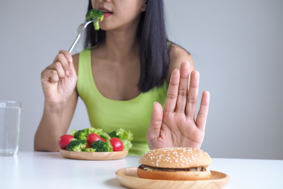 Healthy women choose to eat vegetable trays and refuse to eat hamburgers.